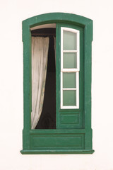 Obraz premium White wall with a green framed opened window