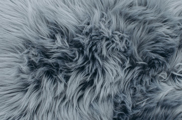 Close up shot of abstract fur background. Grey artificial fur texture
