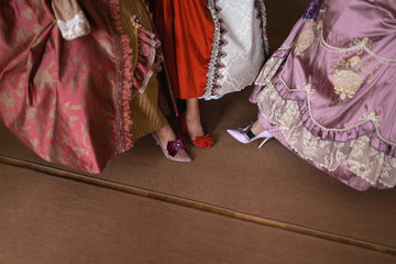 Retro style royal medieval ball - Majestic palace with gorgeous people dressed in king and queen's friends dresses with accessories such as fan and hand puch as a handbag - 2019 © dissx