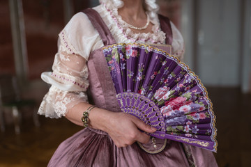 Retro style royal medieval ball - Majestic palace with gorgeous people dressed in king and queen's friends dresses with accessories such as fan and hand puch as a handbag - 2019 © dissx