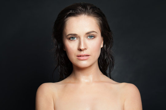 Healthy model with natural wet skin on black