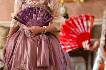 Retro style royal medieval ball - Majestic palace with gorgeous people dressed in king and queen's friends dresses with accessories such as fan and hand puch as a handbag - 2019