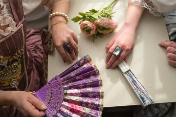 Retro style royal medieval ball - Majestic palace with gorgeous people dressed in king and queen's friends dresses with accessories such as fan and hand puch as a handbag - 2019 © dissx