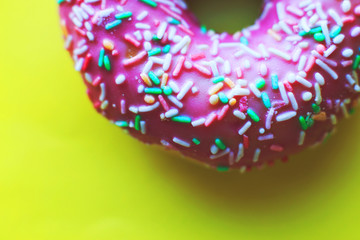pink donut on a yellow background close