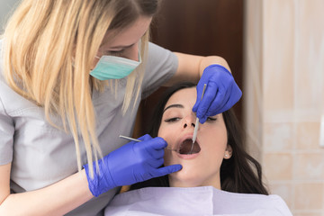 Dentist checking up patient teeth
