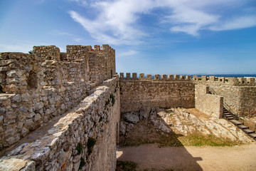 castle interior with blue sky and white clouds above