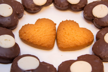 biscuits heart,A couple of heart shaped cookies in the middle of the chocolate bar cookies