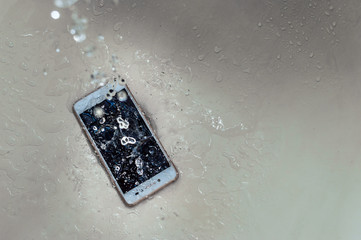Mobile phone dropped into the water in the bathroom