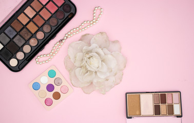 Woman's accessories and make up products on pink background 