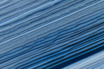 Abstract colored background in blue tones. Background of smooth blue stripes.