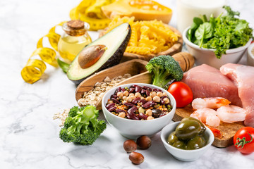 Mediterranean diet concept - meat, fish, fruits and vegetables on bright green background