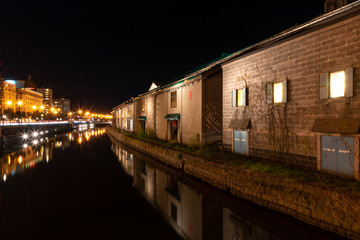 Fototapeta na wymiar Landscape view of Otaru canals and warehouse at night in Hokkaido Japan.