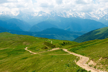 Fototapeta premium Mestia, Georgia - Jun 25 2018: Hiking trail leading from Mestia to Koruldi lakes. a famous landscape in Mestia, Samegrelo-Zemo Svaneti, Georgia.