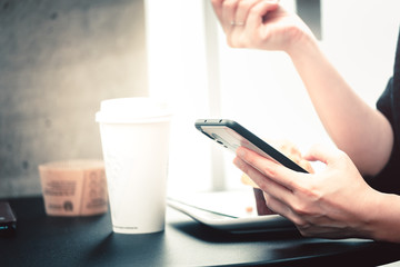 Young asian woman using cellphone  in coffee shop.