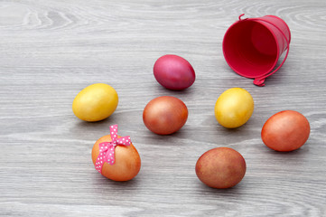 Easter eggs on a wooden gray table. Greeting card with Easter.