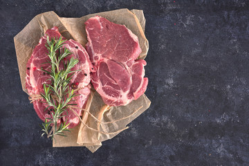 Raw meat steak on dark background. Copy space text concept. Fresh rosemary. © Kalina Georgieva
