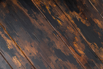 Old wooden surface background, scuffed boards with black paint stains.