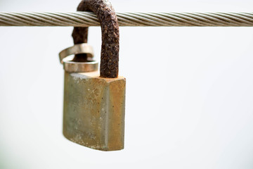 Steel cable with padlock and rings symbolizing marriage, love, loyalty and security