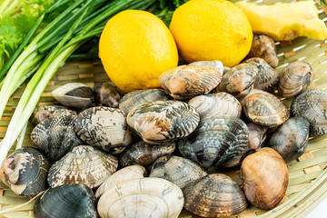 Bamboo sifter filled with fresh flower and spice ingredients