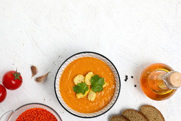  Rich in vegetable protein lentil soup puree with croutons ,cereals and bread. on a white textured background. top view . copy space .