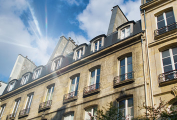 Fototapeta na wymiar Old buildings of Paris against the blue sky, France