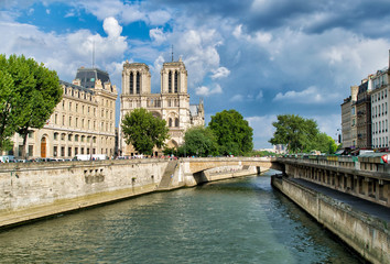 PARIS, FRANCE - JULY 2014: Exterior view of Notre Dame with tourists. This is the most visited landmark in France