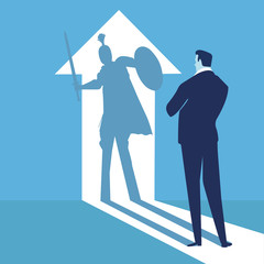 Fototapeta premium Business power concept. Businessman standing in front of his own muscular shadow showing his super inner strength.
