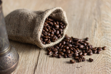 The sack of coffee beans on wooden table