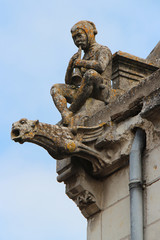 gargoyles on the roof of a medieval church in luché-pringé (france)