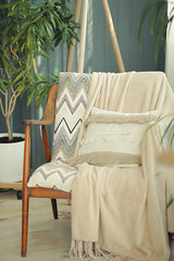 Beautifully decorated farmhouse look. cozy country chair with a beige blanket as an element of the interior