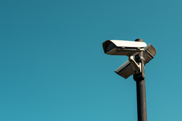 Security cameras with blue sky as background