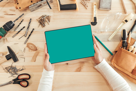 Female carpenter using digital tablet computer, mock up screen - Powered by Adobe
