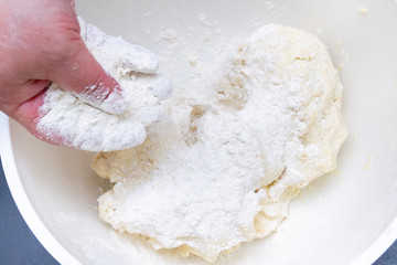 Mixing in a bowl of dough for the preparation of cottage cheese cookies