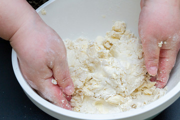 Mixing in a bowl of dough for the preparation of cottage cheese cookies