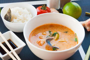 Seafood Thai soup served on white bowl, Thai food cuisine calling Tom Yum Kung.