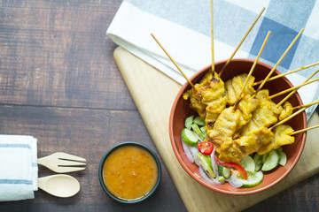 Pork satay with peanut sauce decorated with cucumber sauce, Thai food