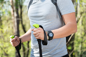 Close up of mans hands trekking in a forest