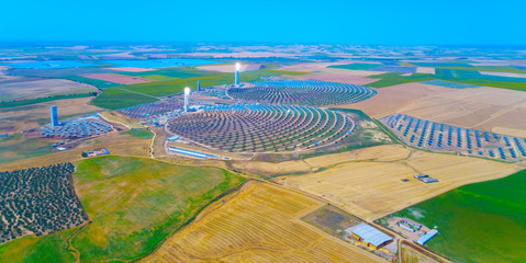 Solar tower surrounded by mirror panels harnessing the sun's rays to provide alternative renewable green energy. Situated in Andalucia, Spain.