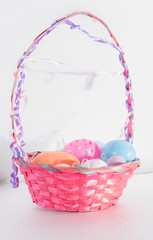colored easter eggs in a wicker basket