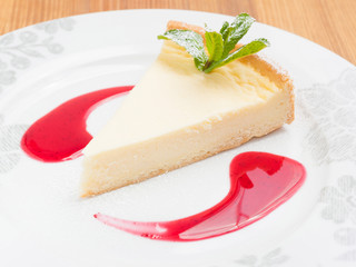 classic cheesecake with mint and berry sauce