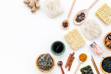 Chinese and Japanese food cooking with ginger, spices and noodles on white background top view mockup