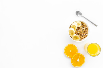Bright breakfast with granola and orange juice on white background top view mockup