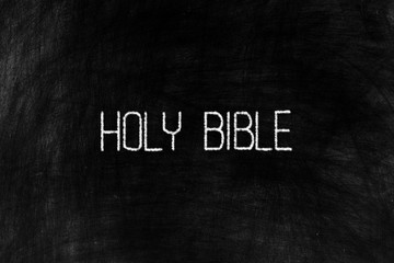 Holy Bible in Chalk Writing on Old Grunge Chalkboard Background.