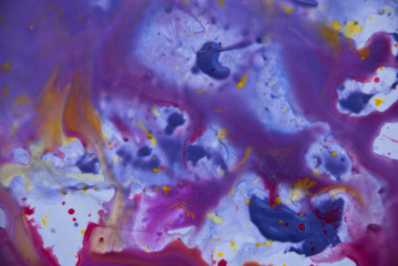 Fototapeta na wymiar Fluid art psychedelic background. Purple pink yellow watercolor paint design.