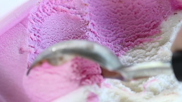 Strawberry and vanilla ice cream scoop close up