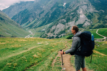 man with a backpack, looking on valley. Hiking around Mont Blanc, Alps Nature,France. Europe