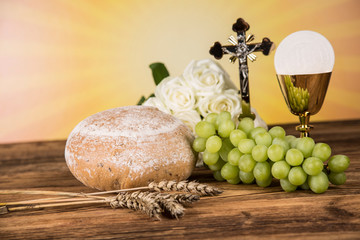 Holy communion a golden chalice with grapes and bread wafers 