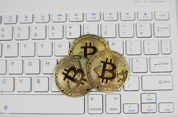 bitcoin on white keyboard, bitcoin is digital currency that only exists electronically