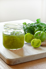 Jam or chutney in a glass jar made of green tomatoes, home canning concept