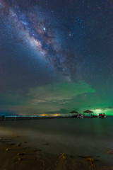 The Milky Way is above the bridge that stretches out into the sea, Koh Mak, Trat, Thailand